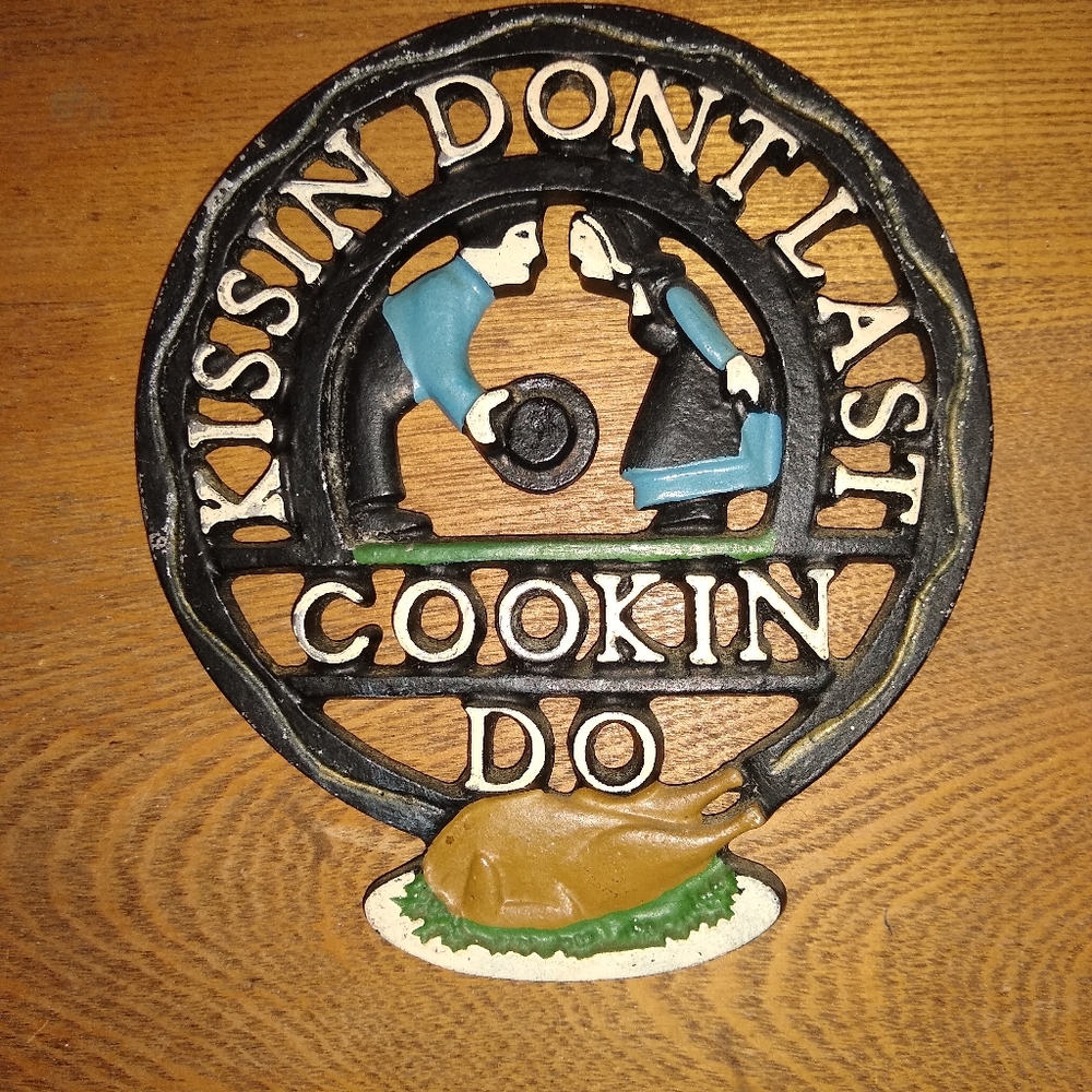 Vintage Cast Iron Trivet, "Kissin' don't last"!